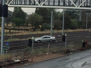 Car stranded on train tracks at Sunshine